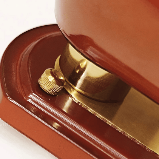 Close-up of a red and gold object, possibly a door handle or a decorative item.