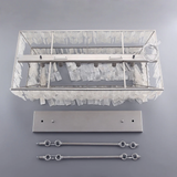 Decorative wall light fixture with clear glass shade and metal components on a gray background