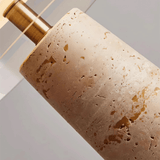 Close-up of a textured cylindrical object with a brass handle on a light background