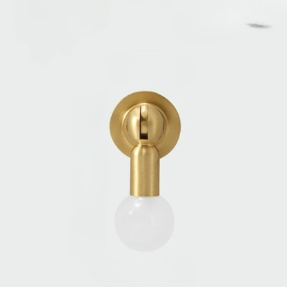 Minimal brass cabinet knob with a frosted white gemstone sphere handle on white background.
