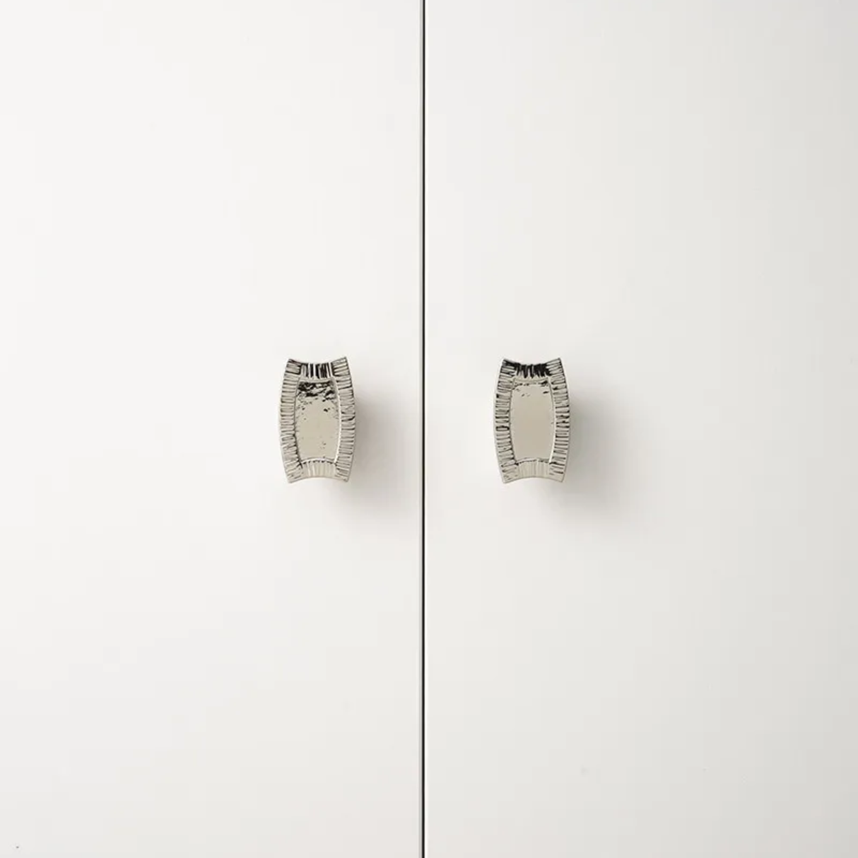 Pair of silver earrings on a white background