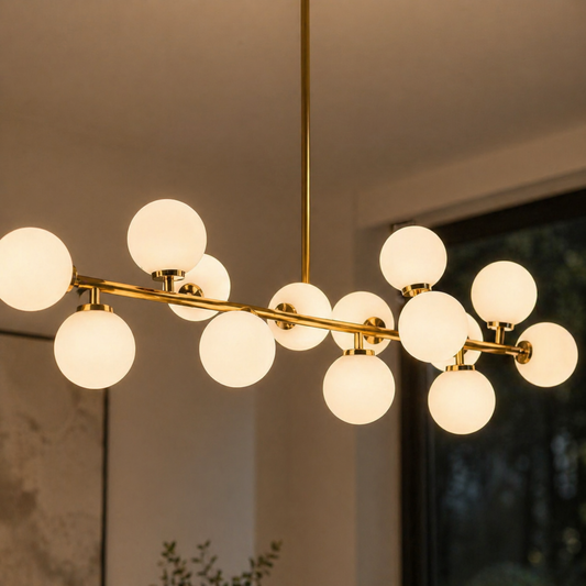 Modern chandelier with multiple round lights and gold fixtures against a neutral background.