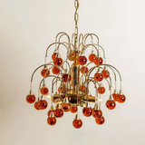 Chandelier with orange glass bulbs on a plain background