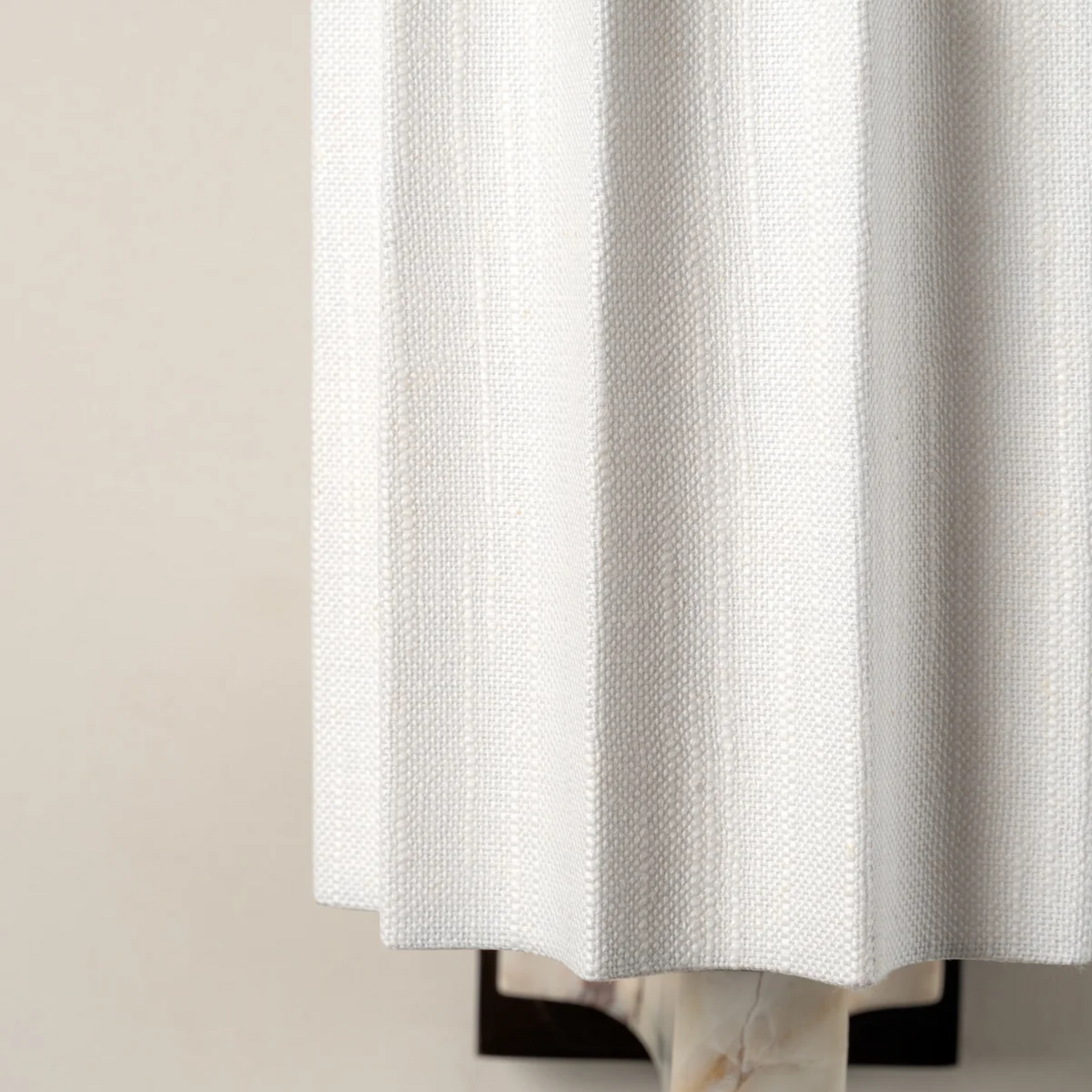 White textured shower curtain on a beige background