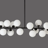 Modern chandelier with multiple round glass lights on a gray background