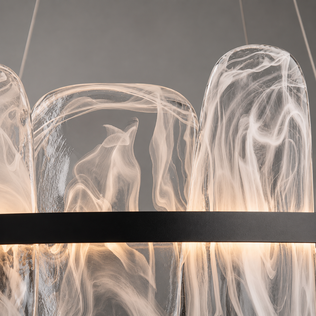 Modern chandelier with glass shades and a black metal frame on a dark background