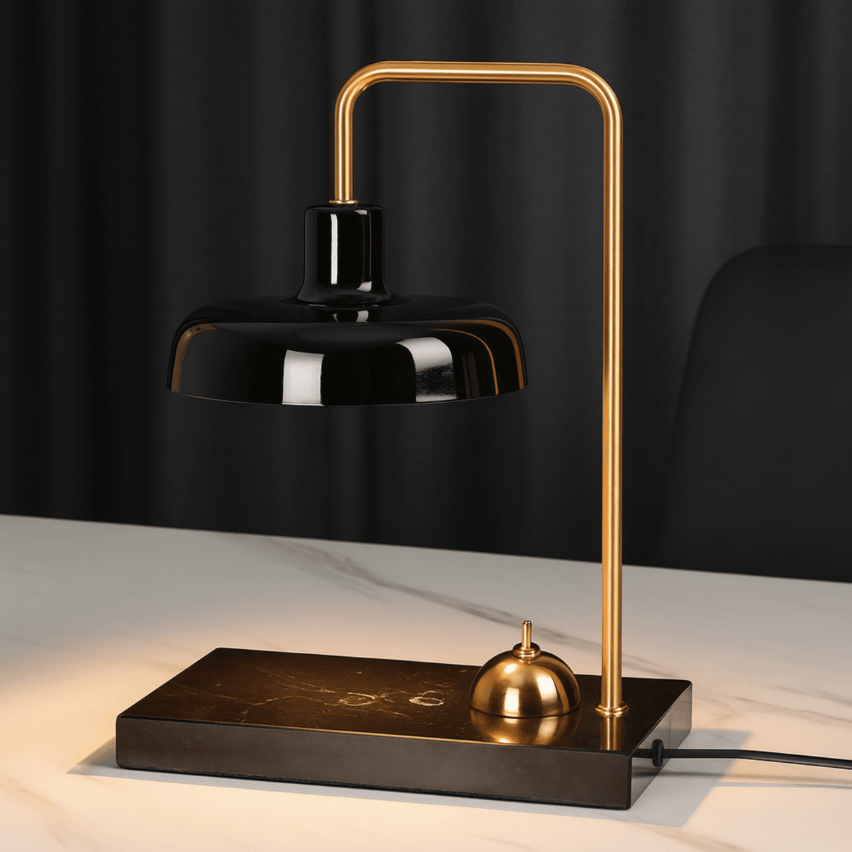 Modern desk lamp with black shade and gold accents on a dark background