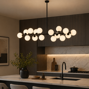 Modern kitchen with a chandelier hanging above a countertop.