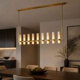 Modern chandelier hanging above a dining table in a stylish room.