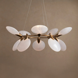 Modern chandelier with white glass shades and gold metal accents on a beige background