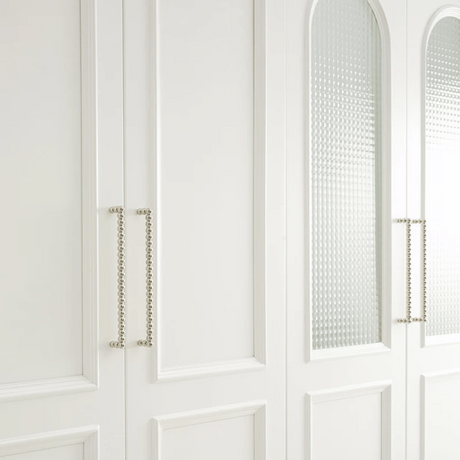 Close-up of a white cabinet with decorative elements