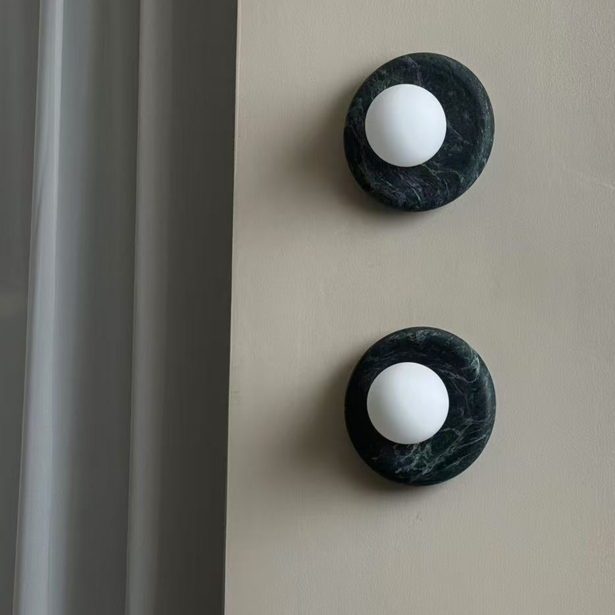 Dark Green Marbella Wall Sconce styled in a bedroom - modern interior by Baskoraa
