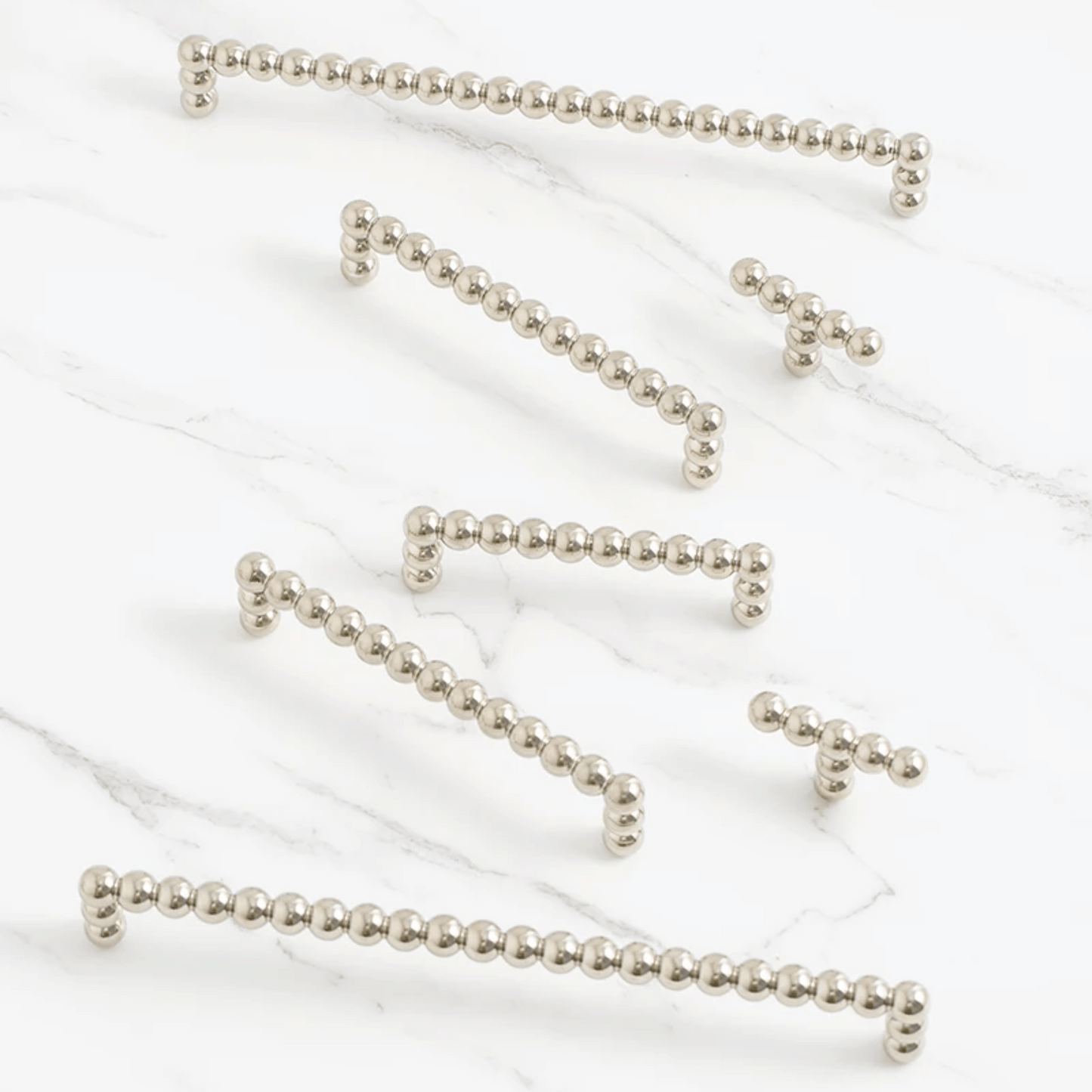 Silver beaded chains on a white background