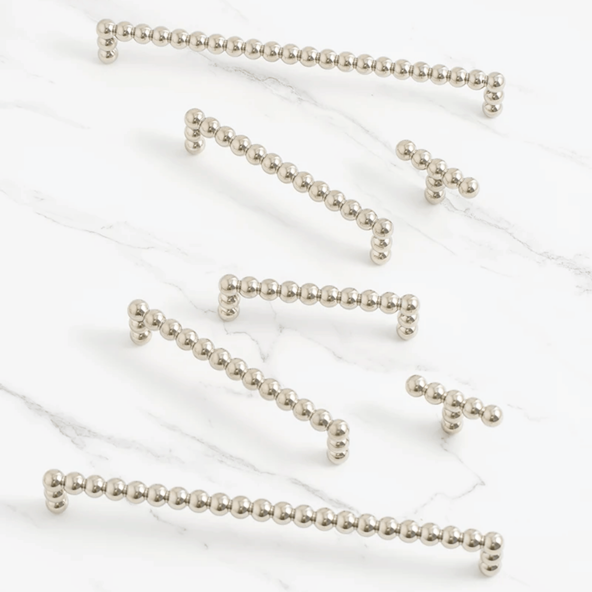 Silver beaded chains on a white background
