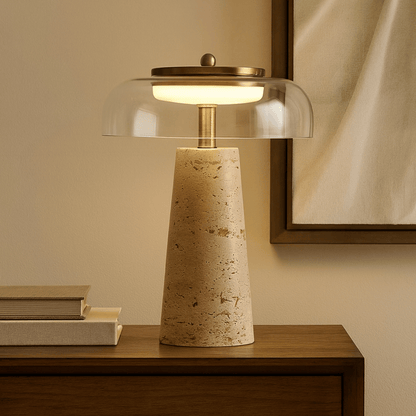 Table lamp with a textured base and clear glass shade on a wooden surface.