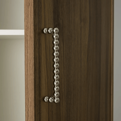 Wooden cabinet with a decorative metal handle