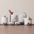 Set of ceramic containers with mountain designs on a neutral background