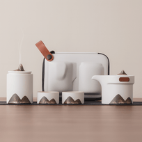 Set of ceramic containers with mountain designs on a neutral background