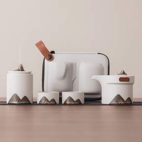Set of ceramic containers with mountain designs on a neutral background