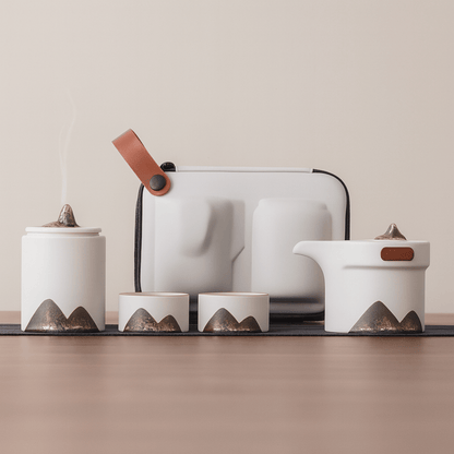 Set of ceramic containers with mountain designs on a neutral background