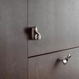 Metallic cabinet handles on a gray wooden cabinet