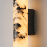 Wall-mounted light fixture with marble-like pattern on a neutral background