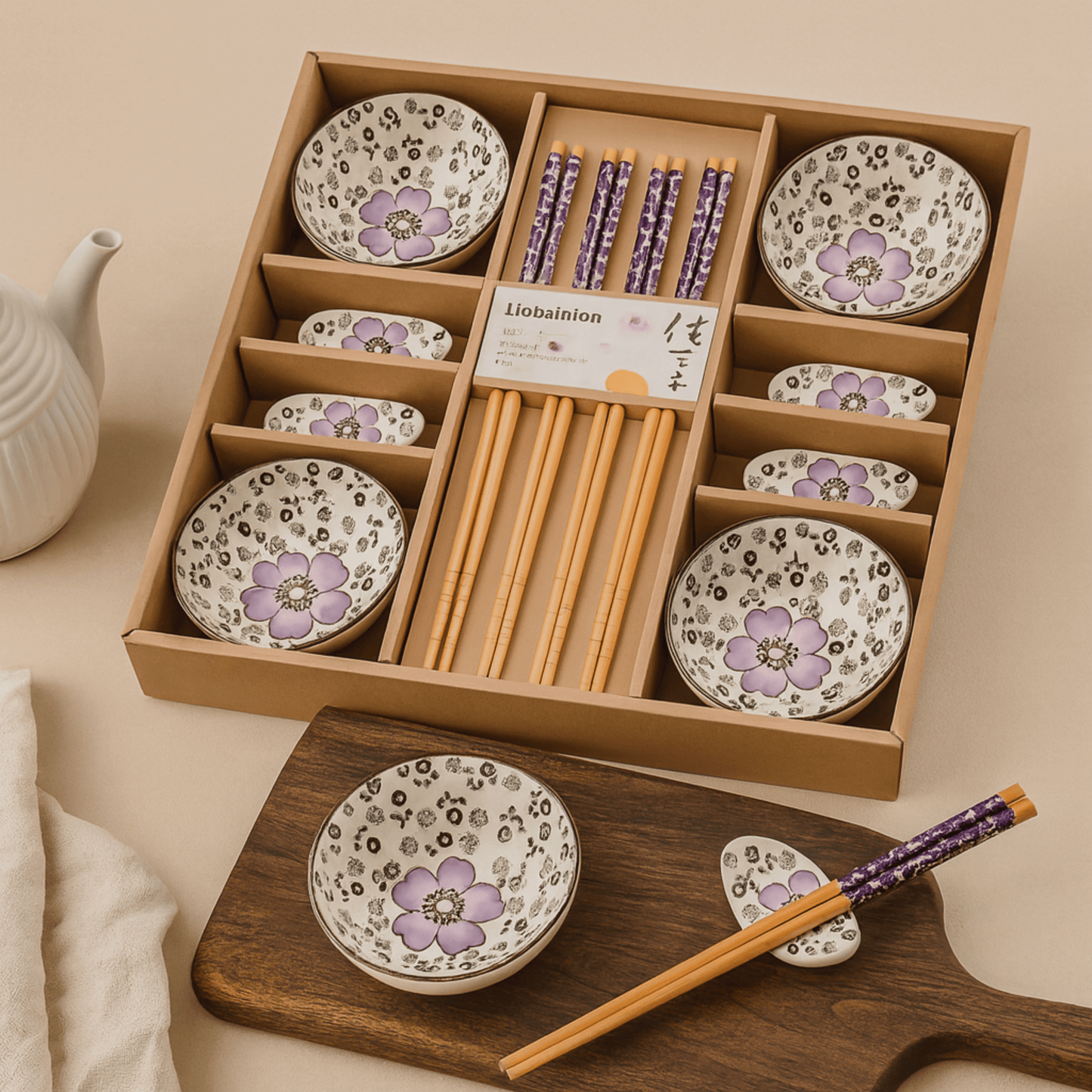 Set of ceramic plates with floral design and wooden chopsticks in a wooden box.