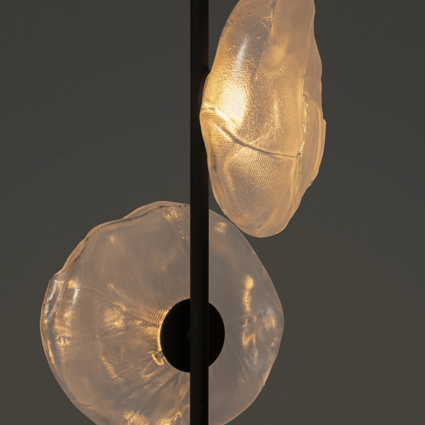 Close-up of a decorative light fixture with textured glass shades on a dark background