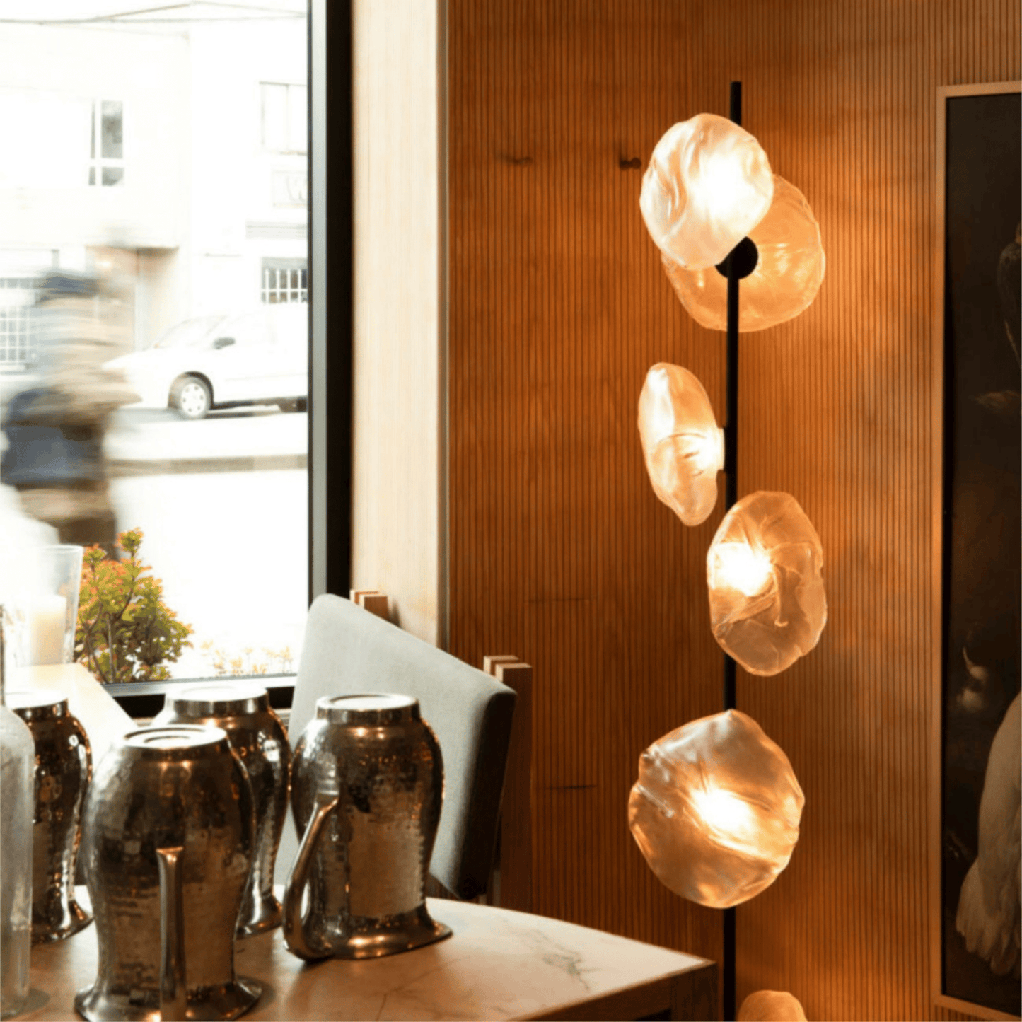 Modern pendant light fixture with glass shades in a room setting.