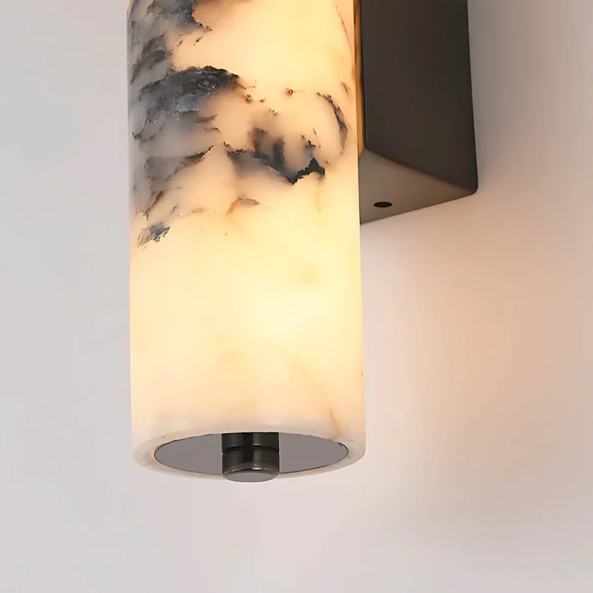 Wall-mounted light fixture with marble-like glass shade on a neutral background