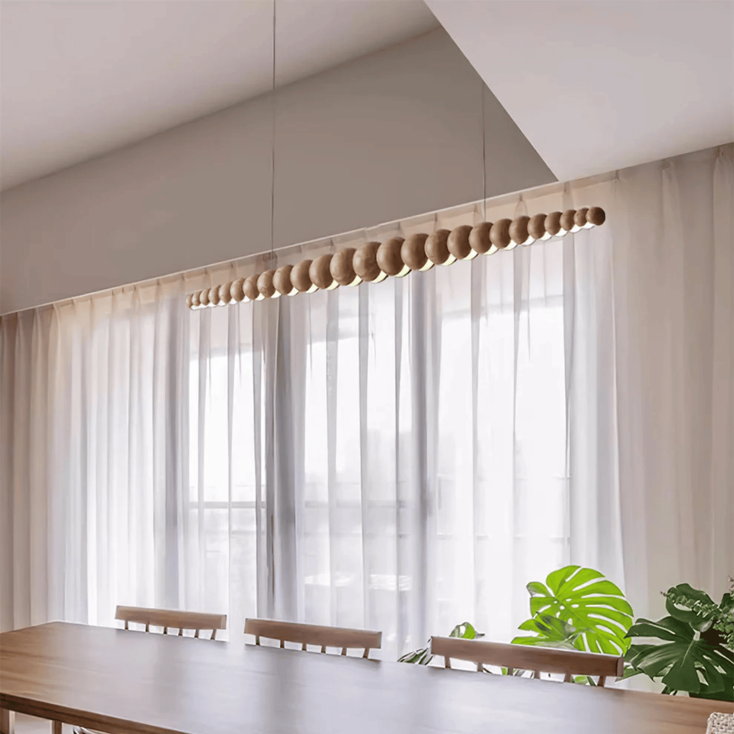 Modern interior with sheer curtains, wooden furniture, and a plant.