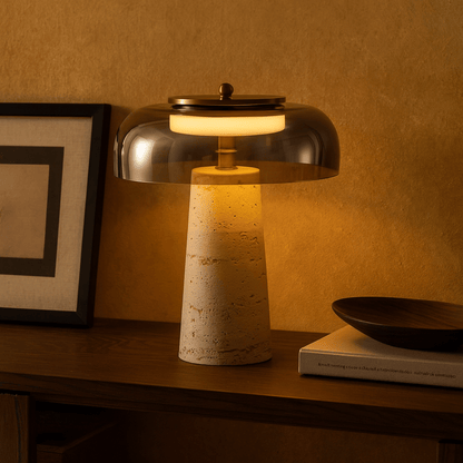 Table lamp with a textured base and metallic shade on a wooden surface.