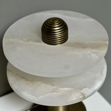 Marble side table with a gold cylindrical accent