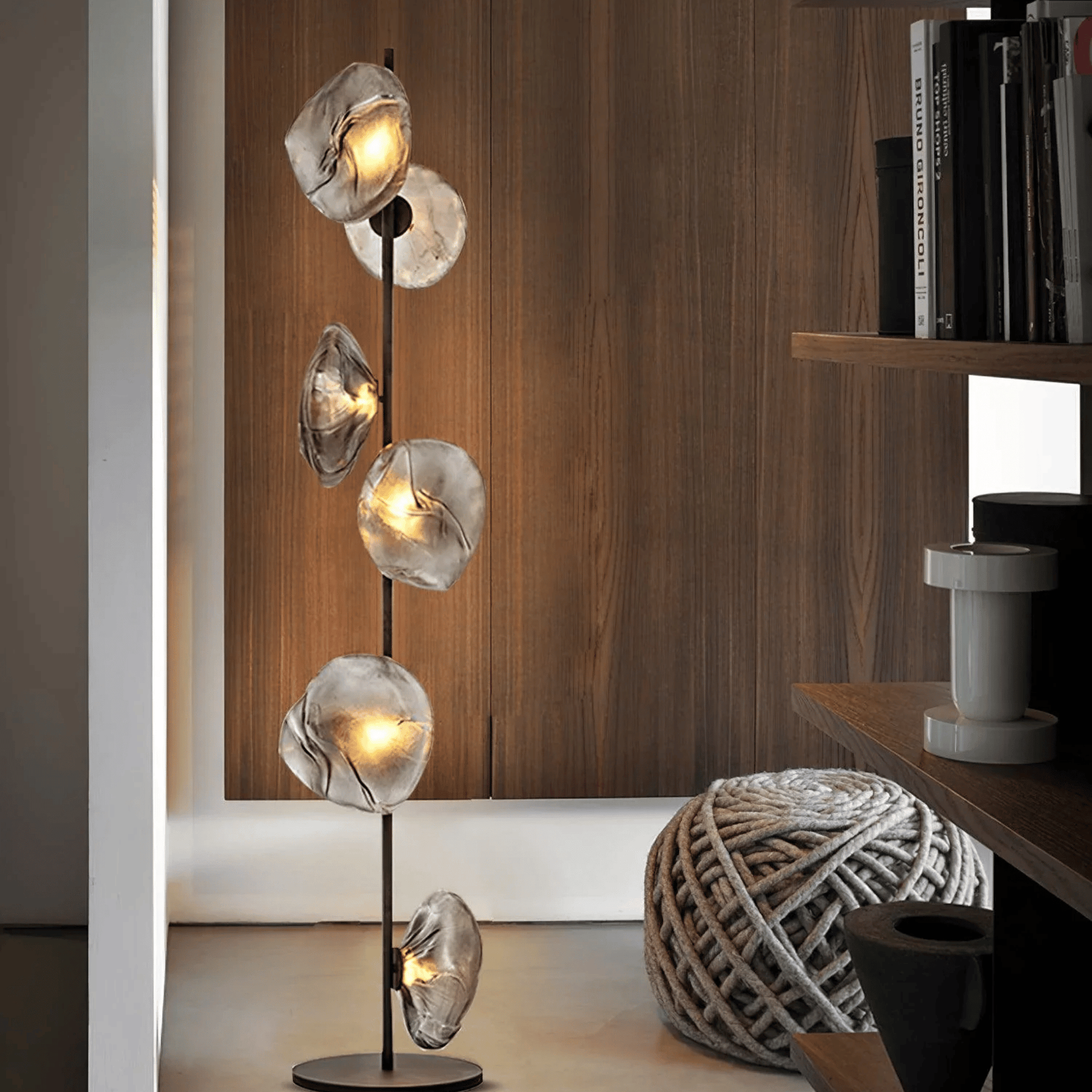 Modern floor lamp with glass shades in a room setting.