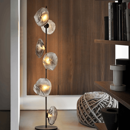 Modern floor lamp with glass shades in a room setting.