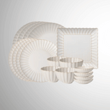 Set of white dinnerware with gold trim on a light gray background