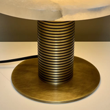 Decorative lamp with striped design on a metallic base
