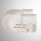 Set of white ceramic dishes with textured patterns on a light gray background