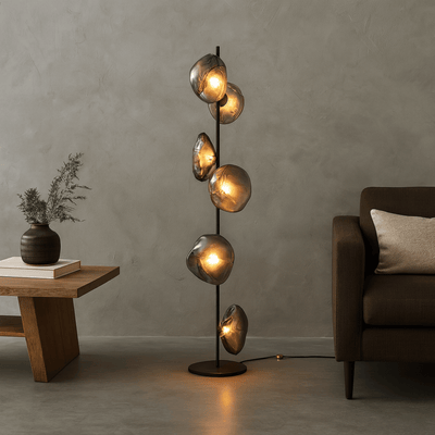 Modern floor lamp with glass shades in a living room setting.