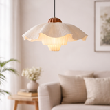 Decorative pendant light in a living room setting with a sofa and plant.