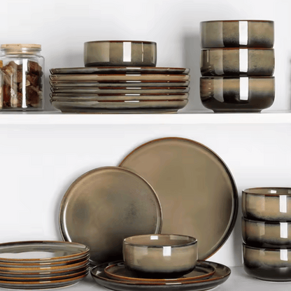 Set of brown ceramic dinnerware on a white background