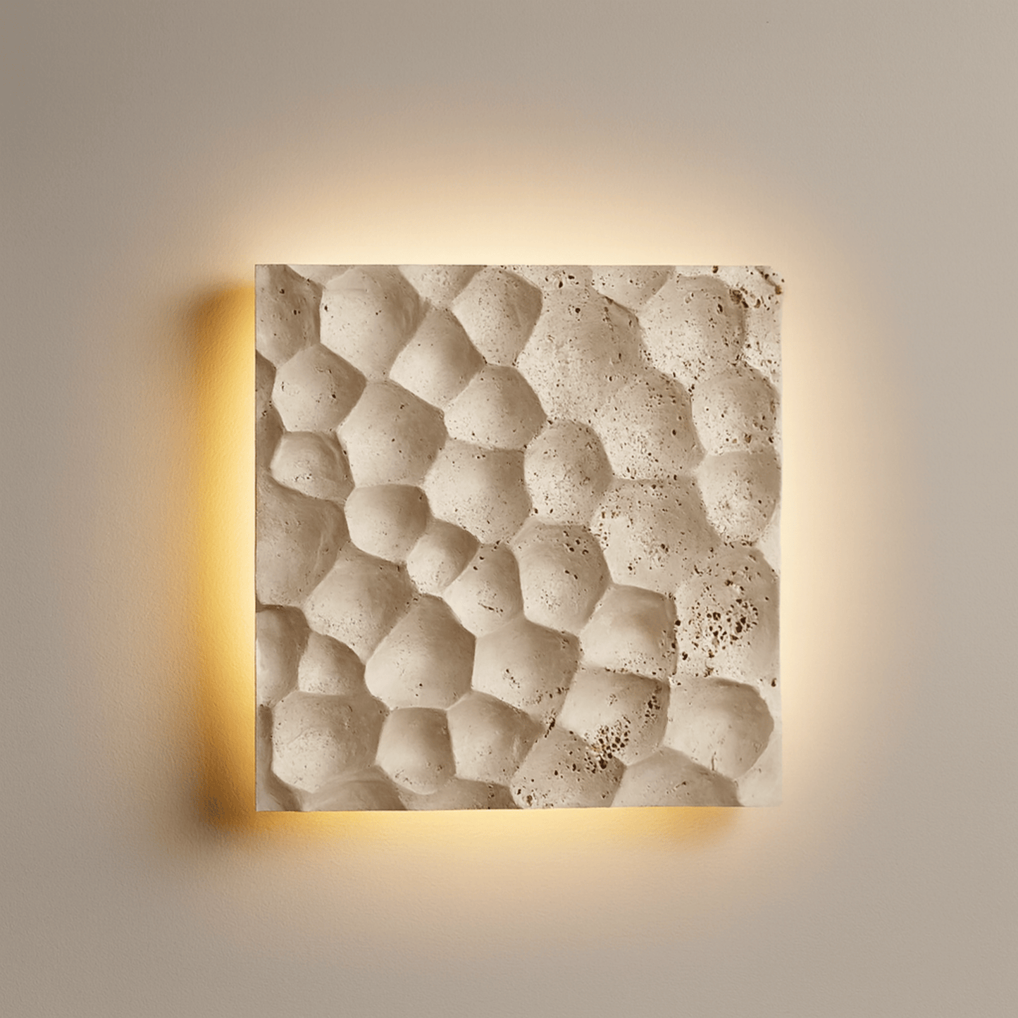 Square wall light with textured beige surface and warm glow on a neutral background