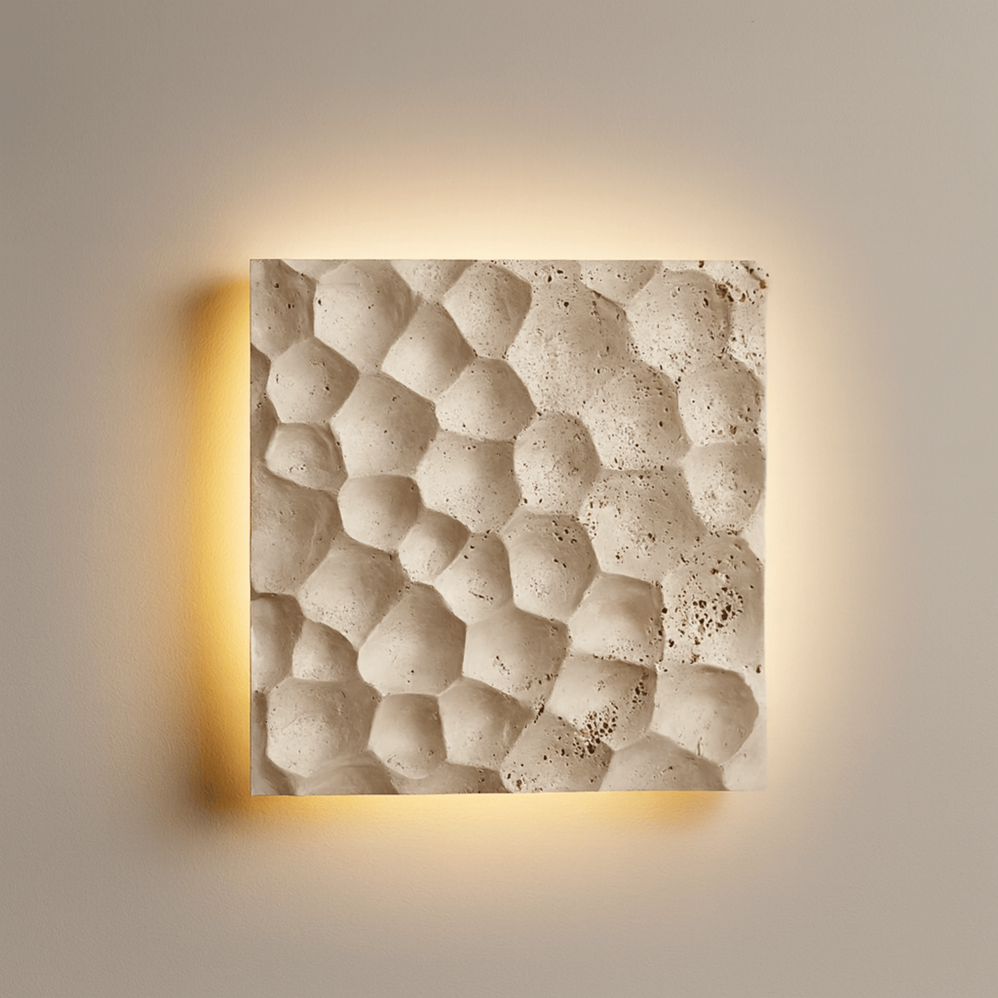 Square wall light with textured beige surface and warm glow on a neutral background