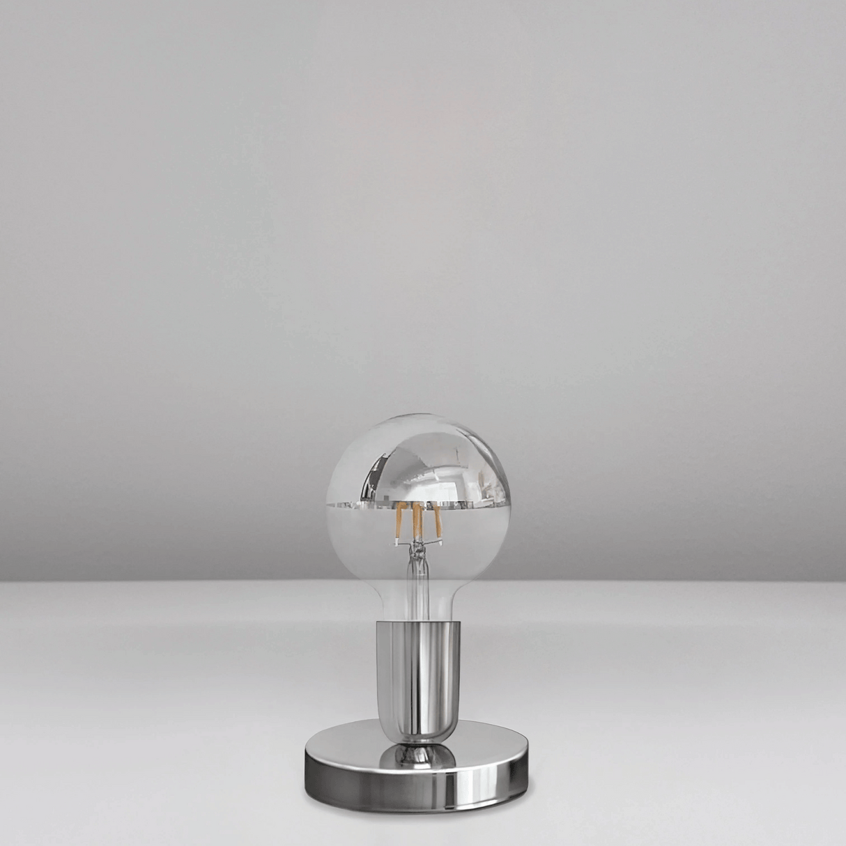 Silver spherical lamp on a gray background