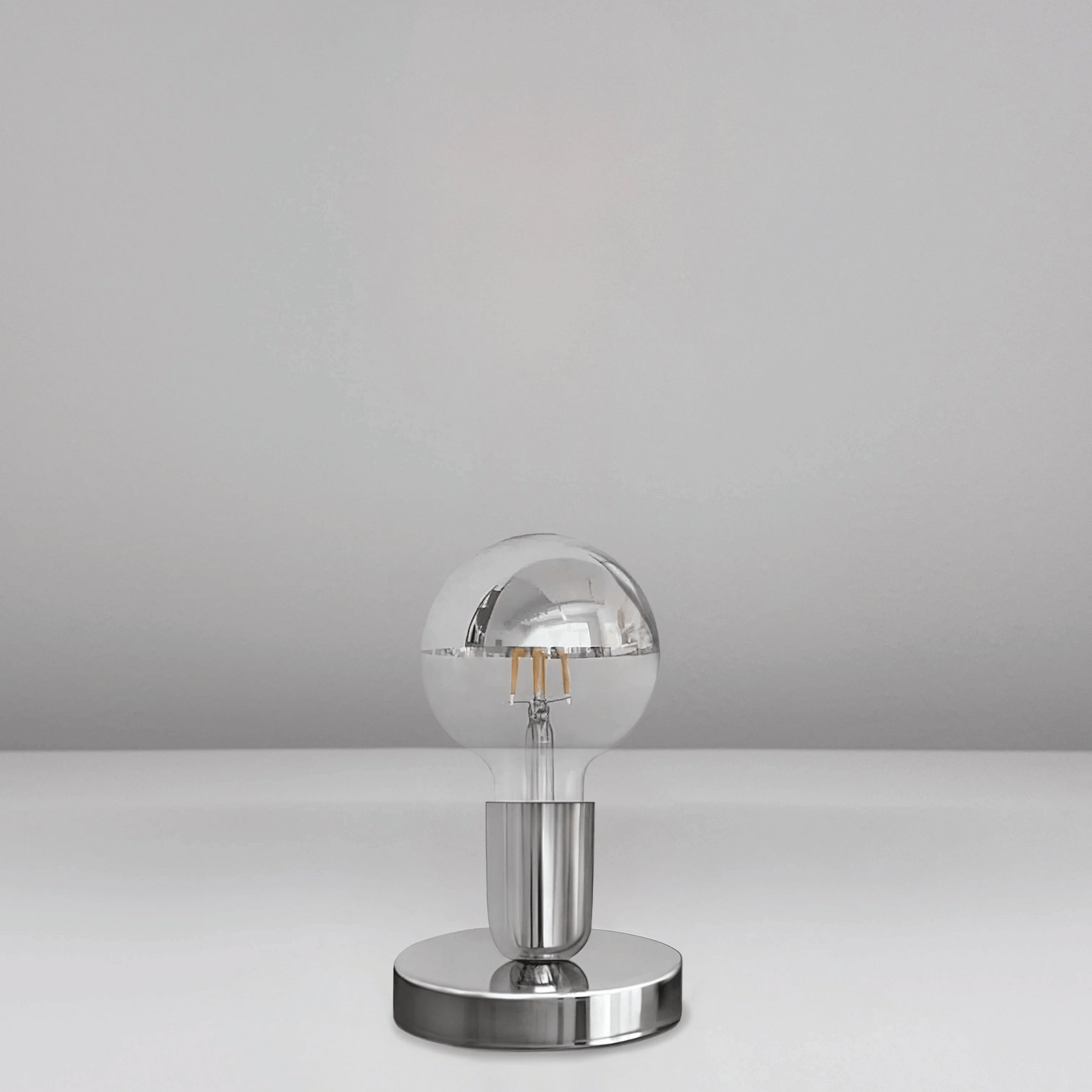 Silver spherical lamp on a gray background