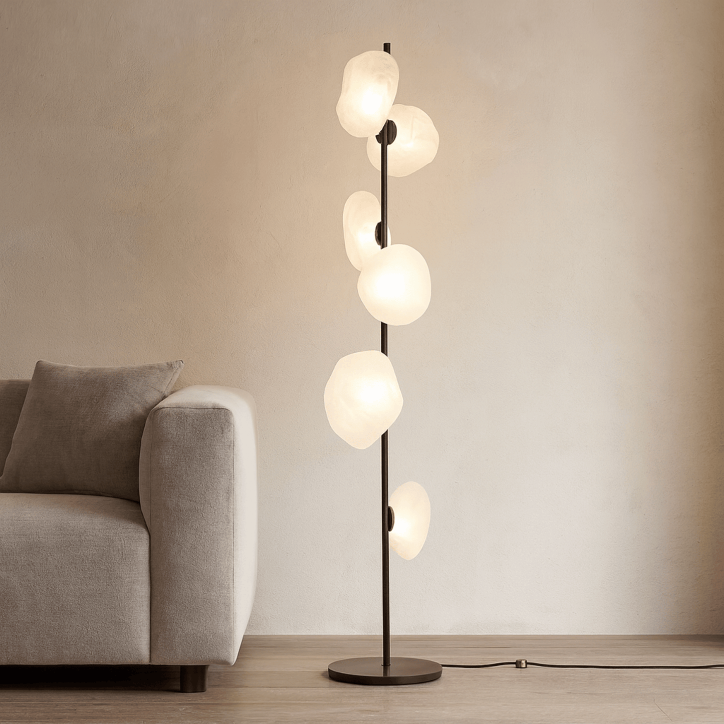 Modern floor lamp with multiple glass shades in a living room setting.