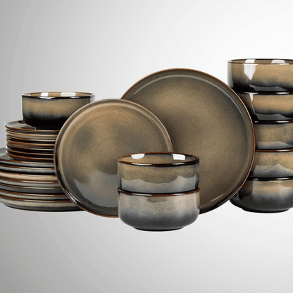 Set of ceramic dinnerware with a metallic finish on a light gray background