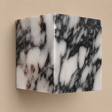 Marble-patterned wall sconce on a beige background