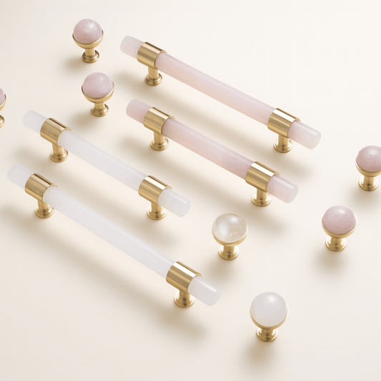 Set of gold and white cabinet handles on a light background