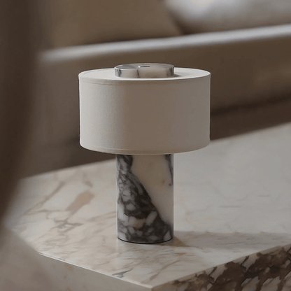 Table lamp with marble base on a marble surface
